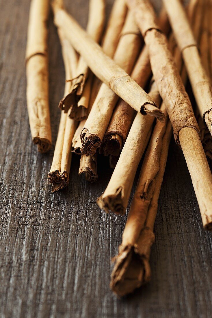 Cinnamon sticks on a wooden surface (close up)