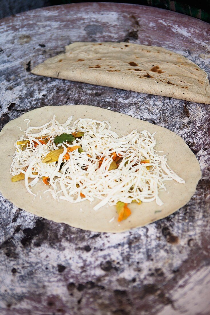 Quesadillas with grated cheese and pumpkin flowers