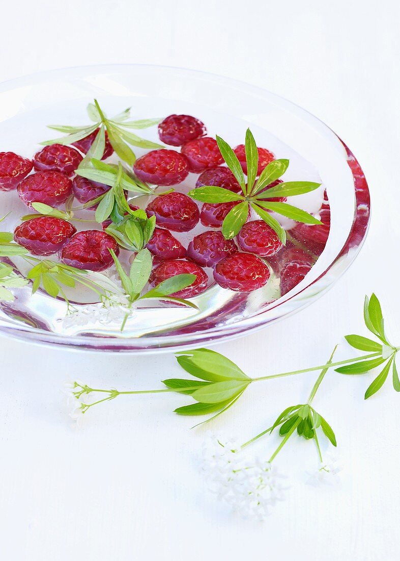 Raspberries in syrup with woodruff