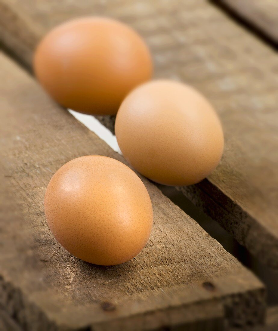Three eggs on a wooden crate