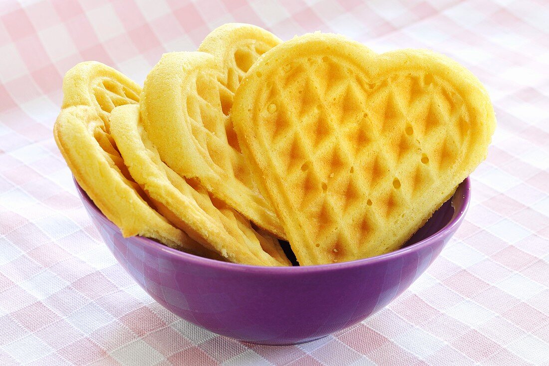 Heart-shaped waffles in a purple bowl