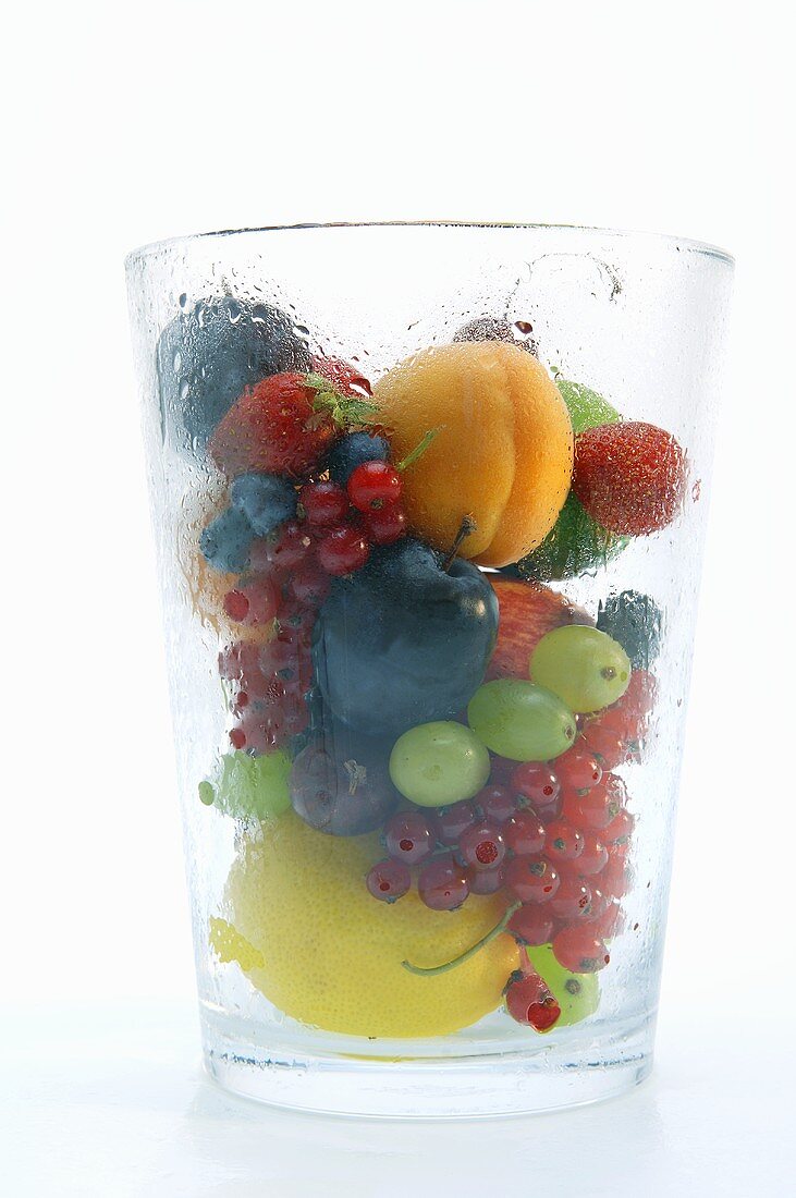 Various types of fruit in a misted glass