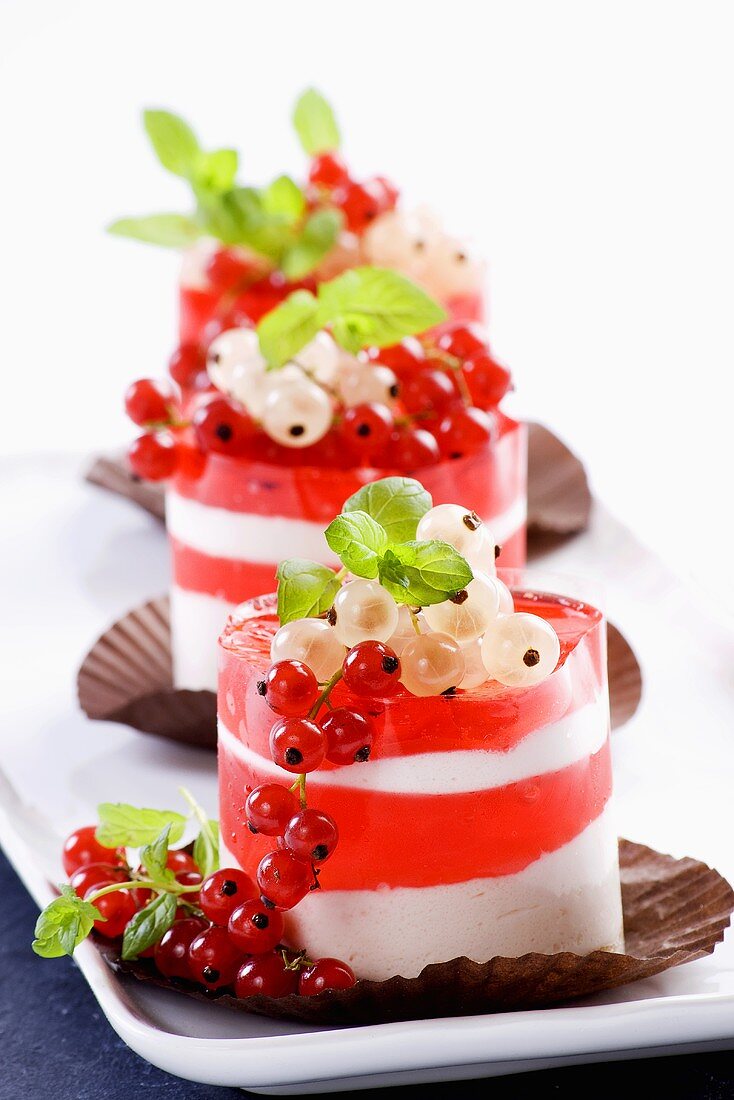 A layered dessert with redcurrent jelly and cream