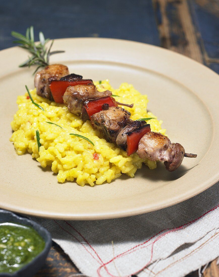 Rabbit and vegetable kebab on a bed of risotto