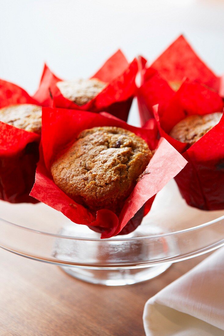 Bran muffins in red paper on a cake stand