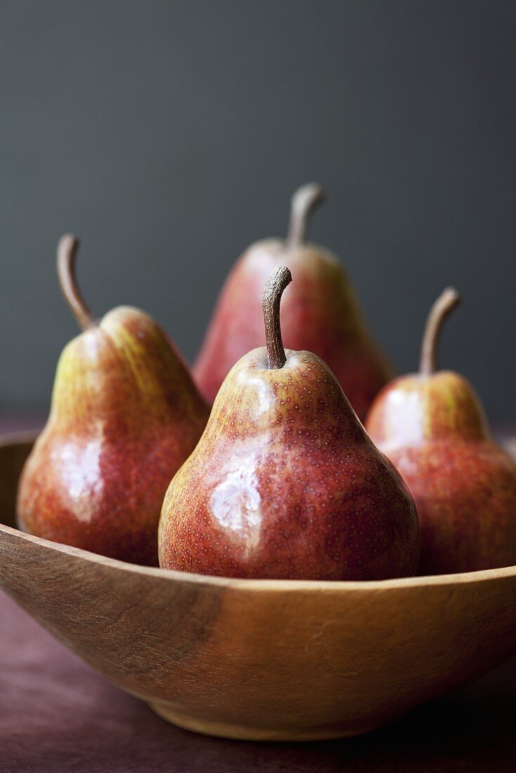 Four Red Pears in Wooden Bowl