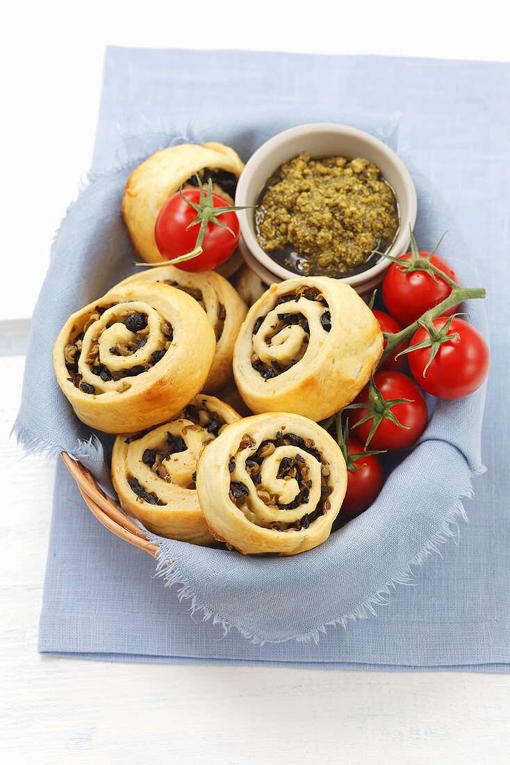 Yeast dough pastries with black and green olives