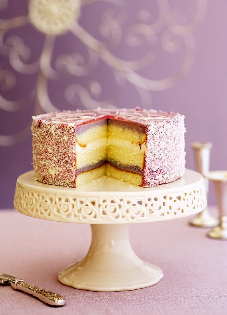 Buttercream blackberry cake on a cake stand
