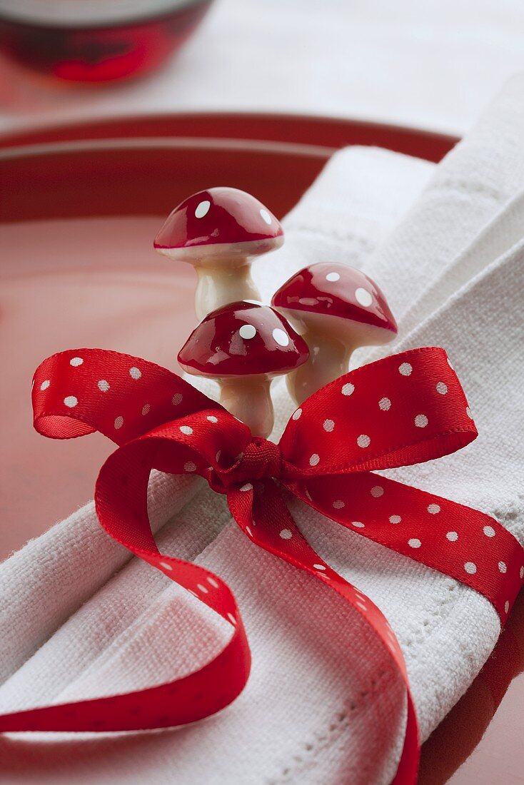 A place setting with a bow and toadstool decorations