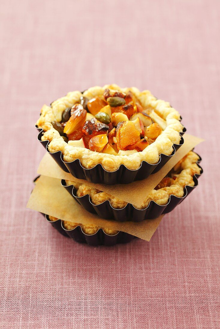 Puff pastry tartlets with apples, apricots, nuts and honey