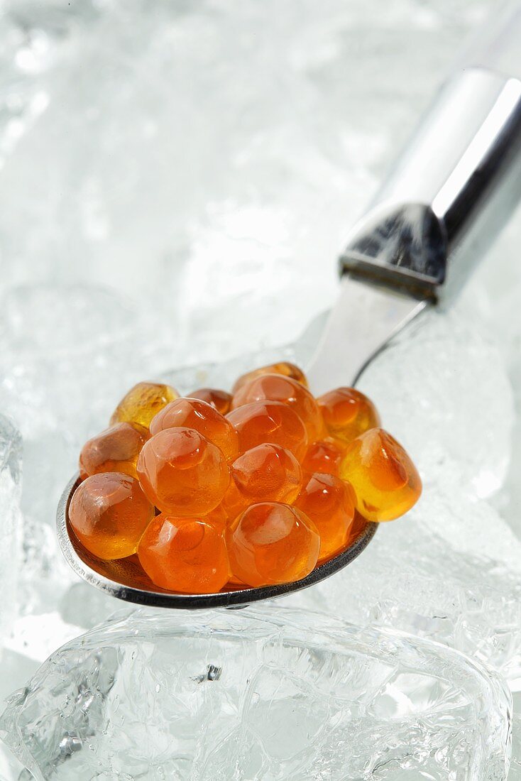 A spoonful of salmon caviar on ice