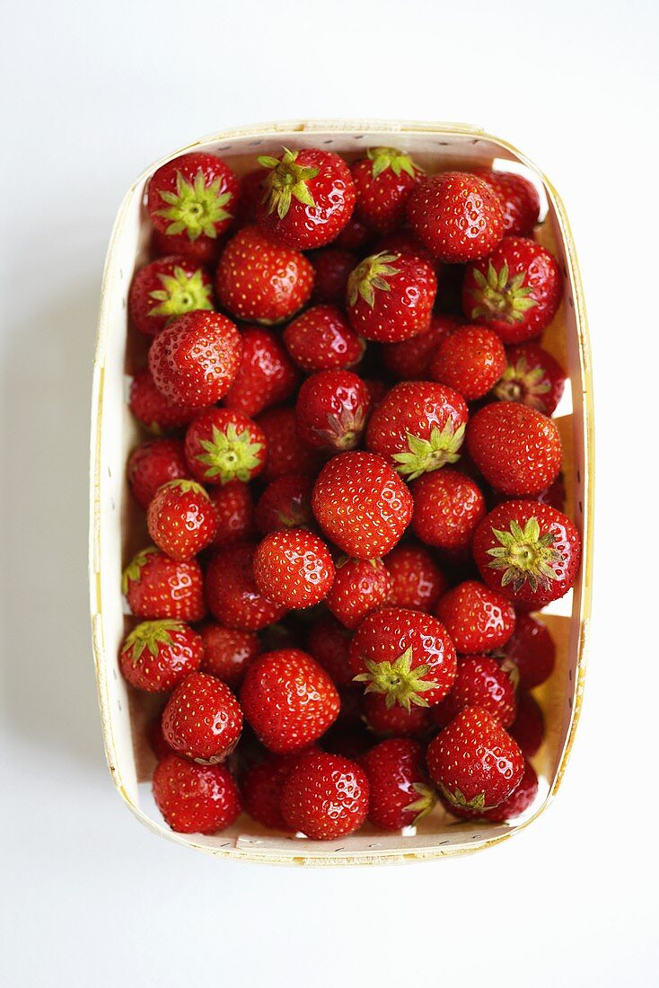 Strawberries in a wooden basket, seen from above