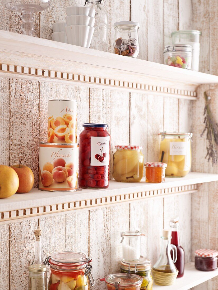 Storage shelf with preserving jars and tinned fruit