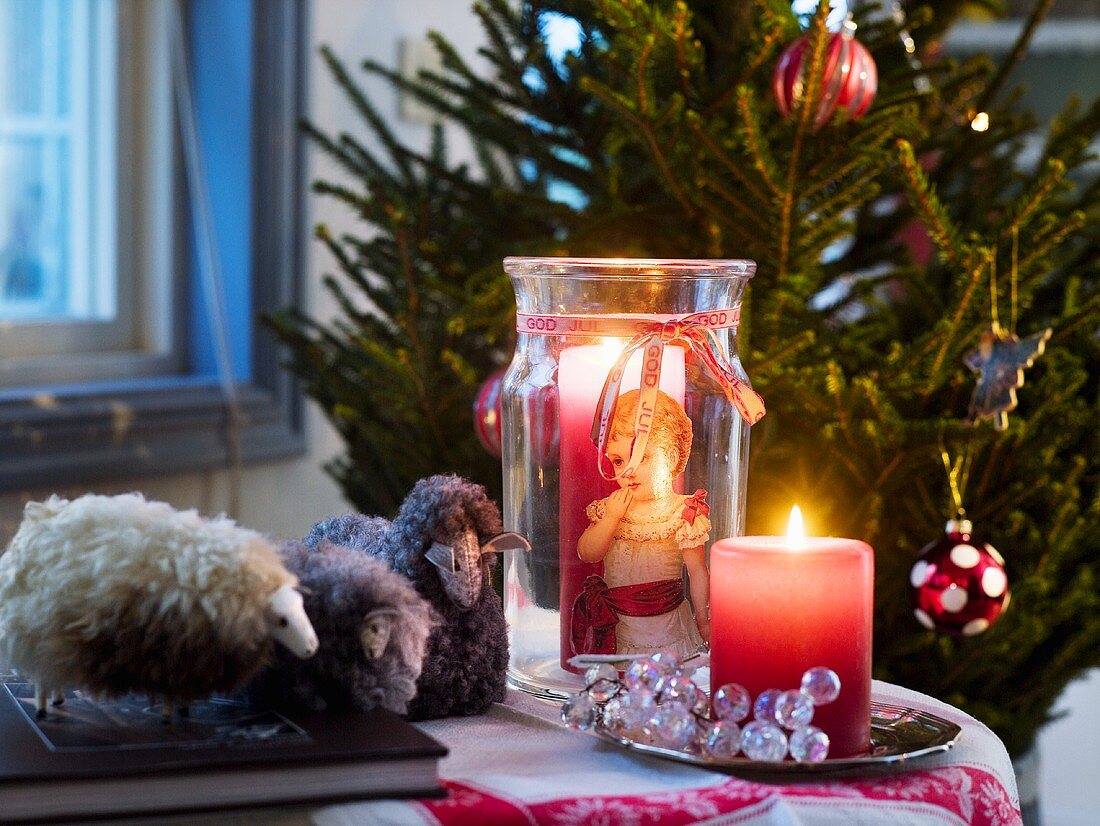 Christmas decoration with candles and fabric lambs