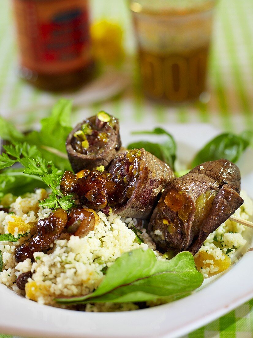 Beef roll kebabs on a bed of couscous