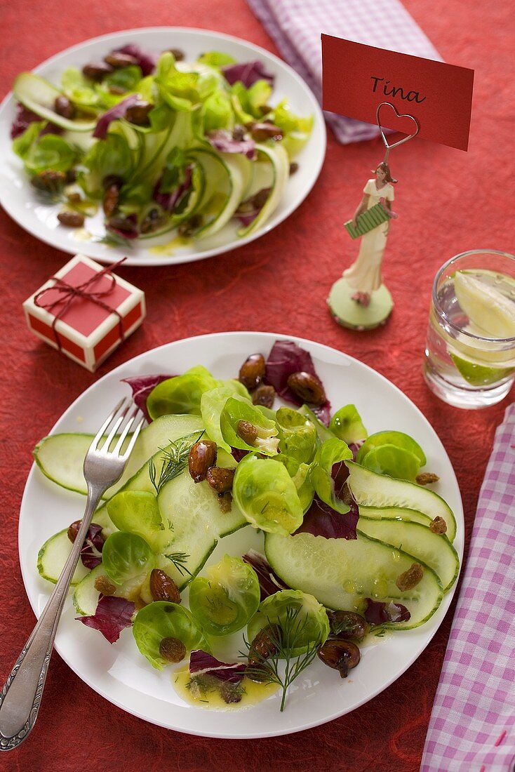 Cucumber salad with brussels sprouts on a laid table