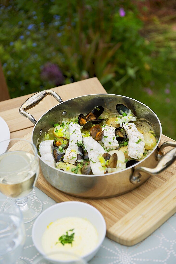 Fish and seafood pan on a garden table