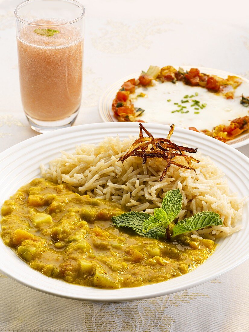 Dhaanshak (lentil curry), peach drink and an Indian egg-cheese dish