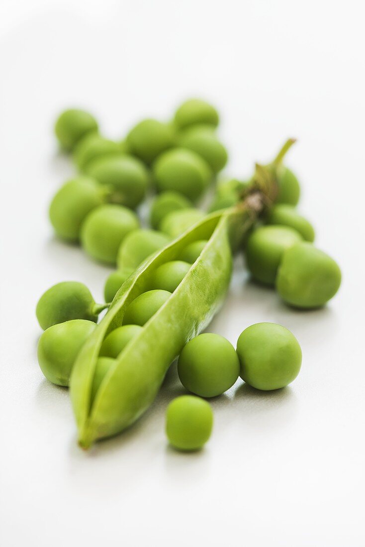 An open pea pod and peas