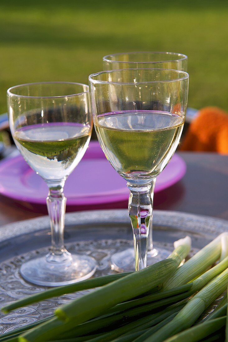 Glasses of wine and spring onions