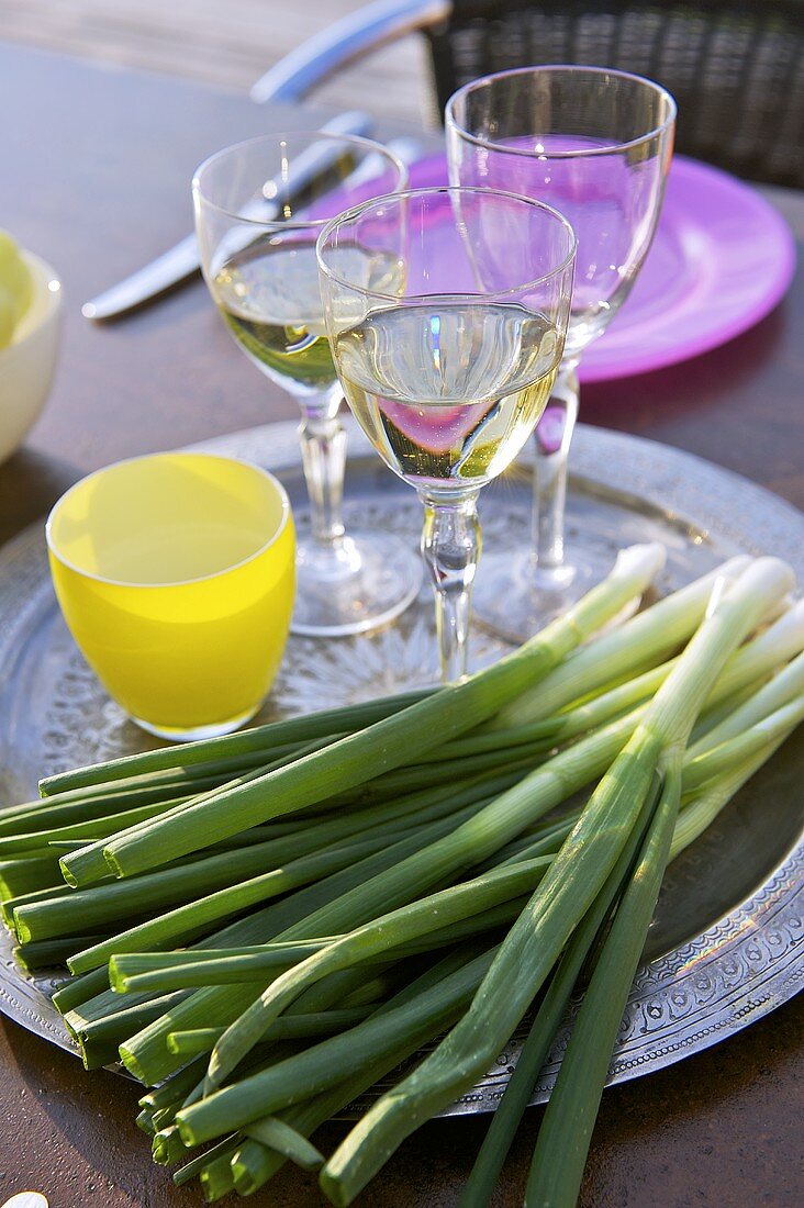 Glasses of white wine and spring onions