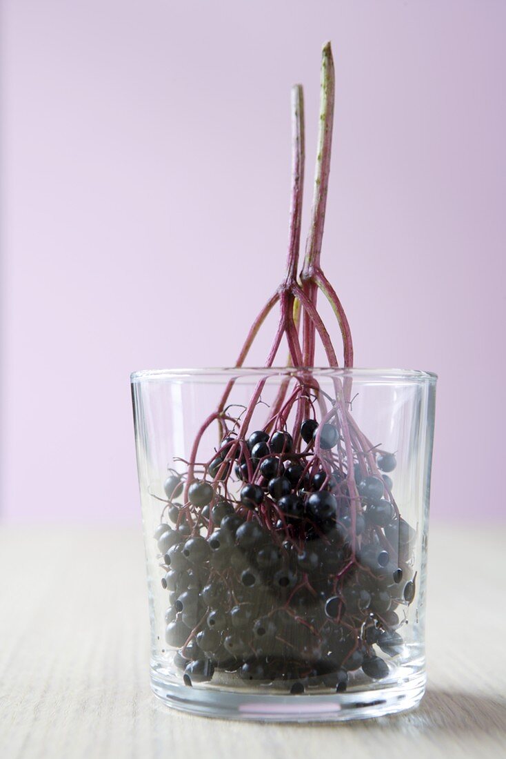 Clusters of elderberries in a glass