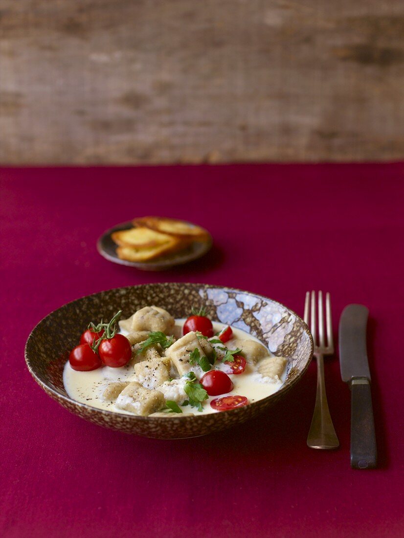 Chestnut gnocchi with Bergkäse cheese sauce & cherry tomatoes