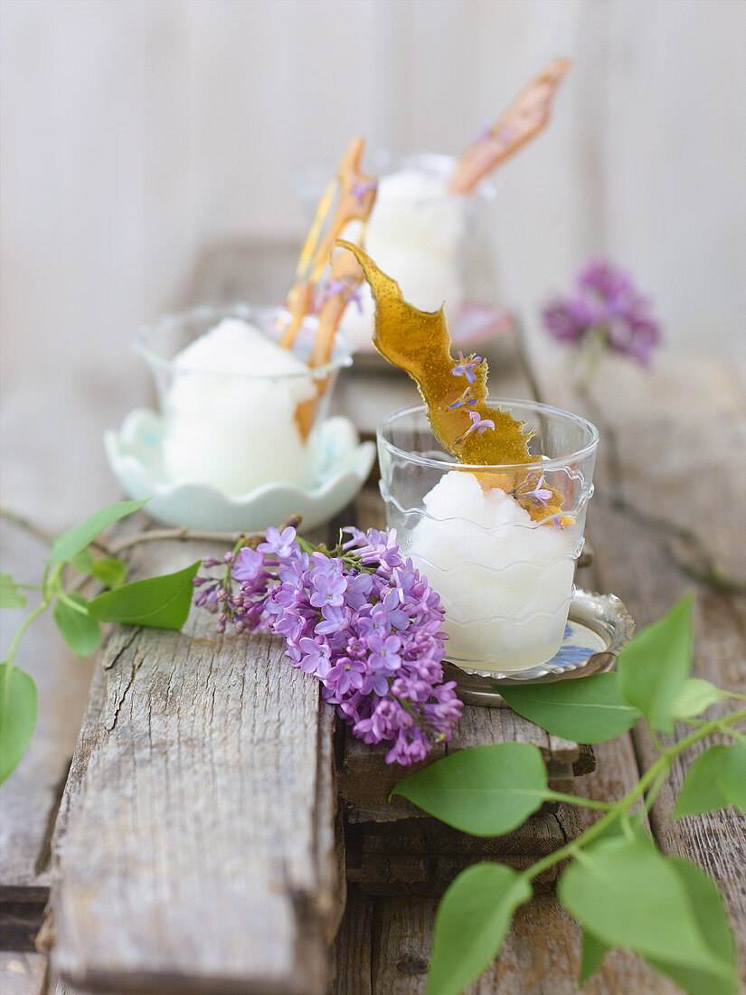Lilac sorbet with caramel on wooden boards out of doors
