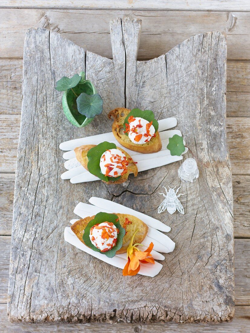 Goat's cheese crostini with nasturtium flowers and leaves