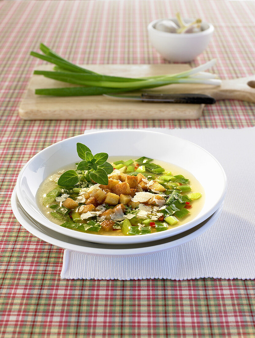 Spring onion soup with croutons and Parmesan