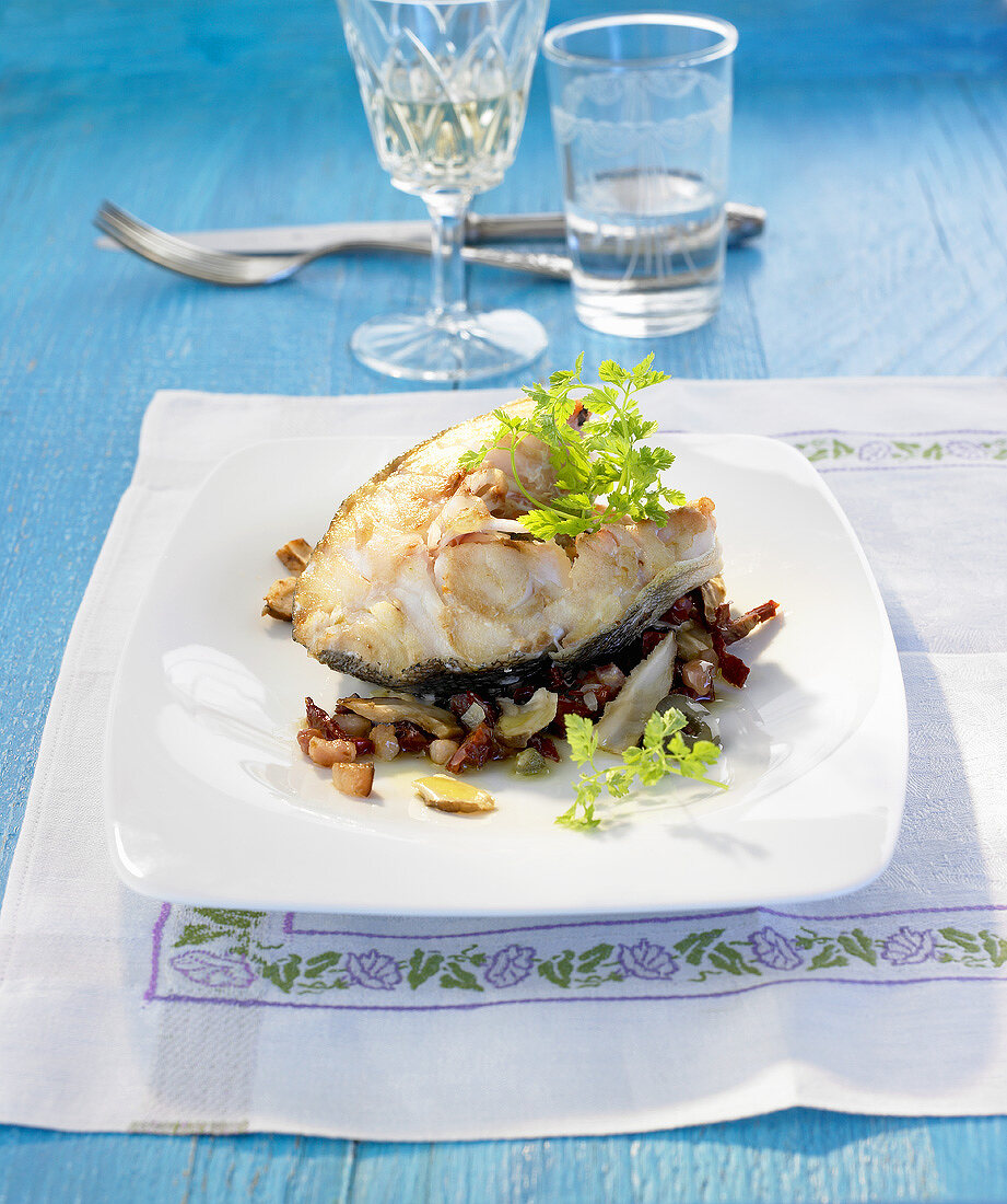 Cod steak with bacon, mushrooms, olives and capers