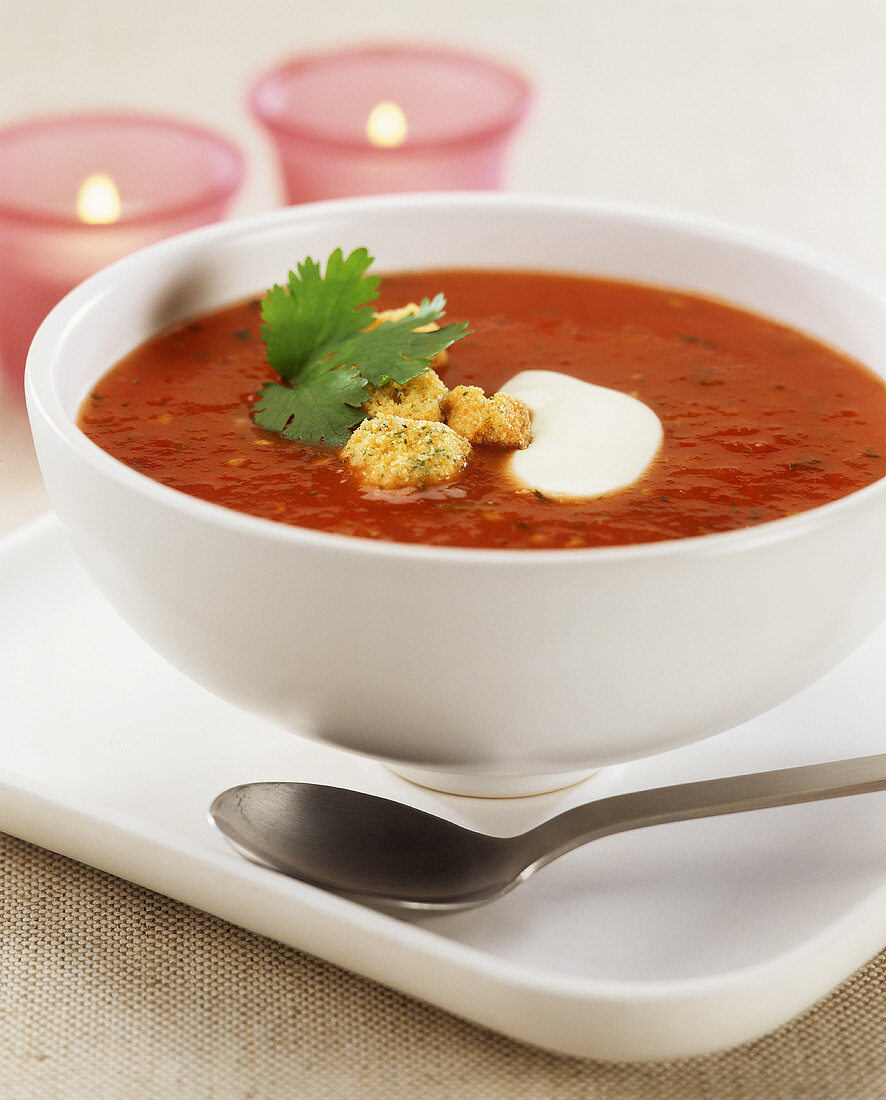 Tomato and pepper soup with croutons in a soup bowl