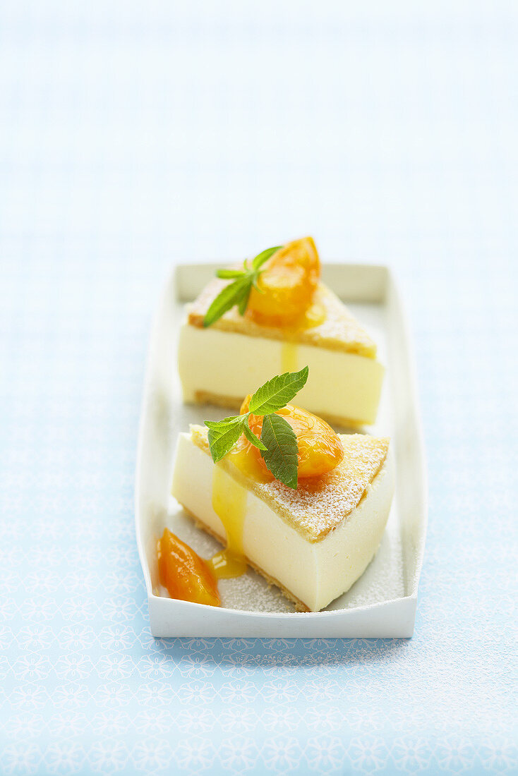 Two pieces of cheesecake with apricot compote
