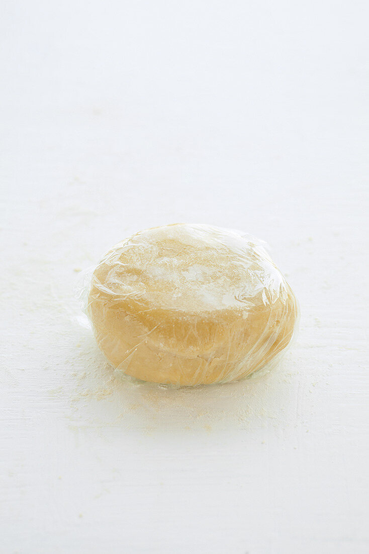 Ball of shortcrust pastry wrapped in cling film