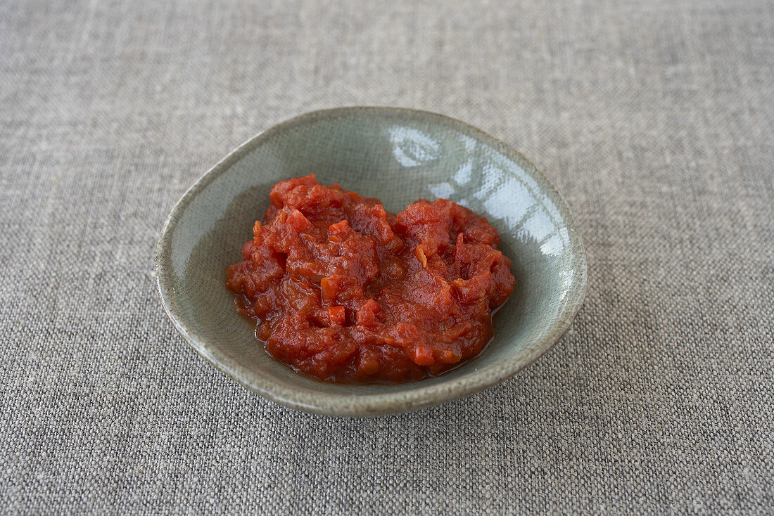 A small dish of barbecue sauce