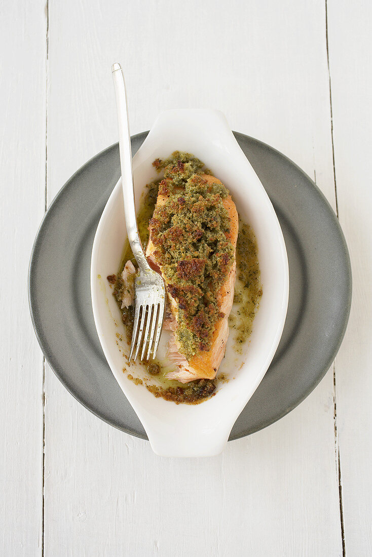 Salmon fillet with herb crust in a baking dish
