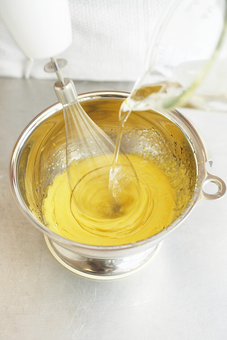 Whisking oil into egg yolk for mayonnaise