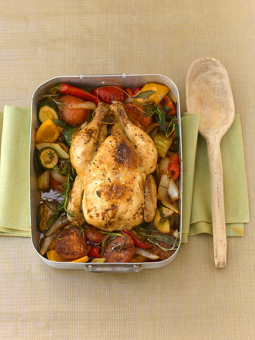 Whole chicken braised with vegetables and herbs