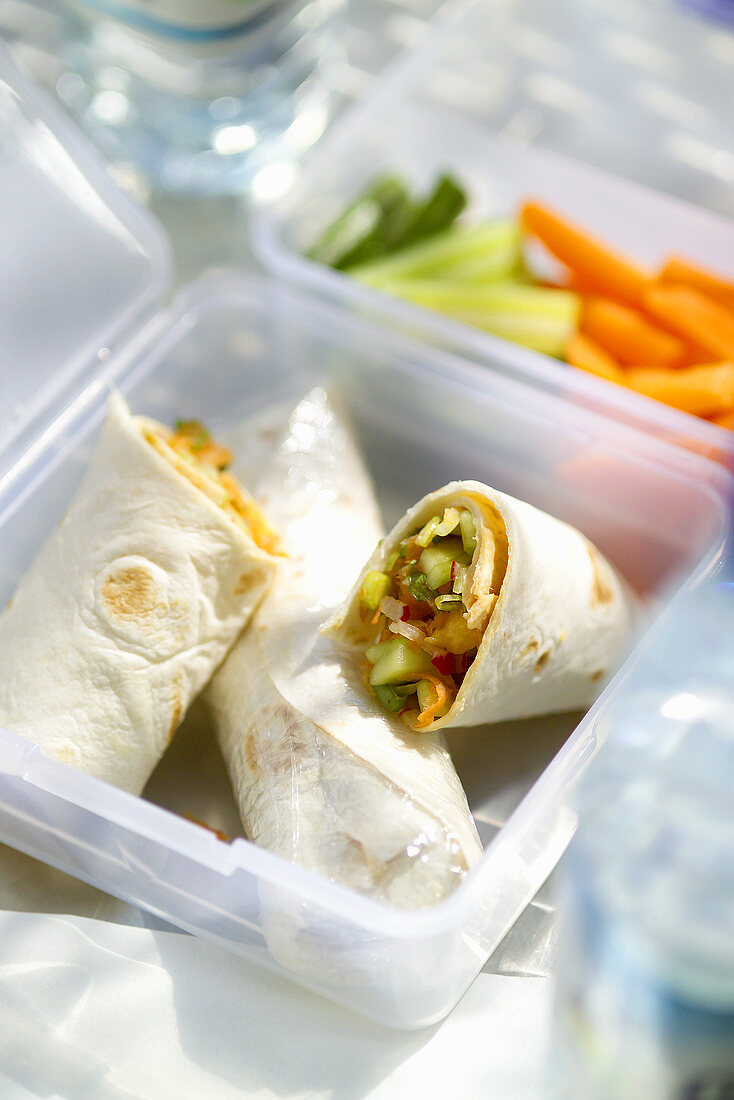 Wraps filled with vegetables in a plastic box