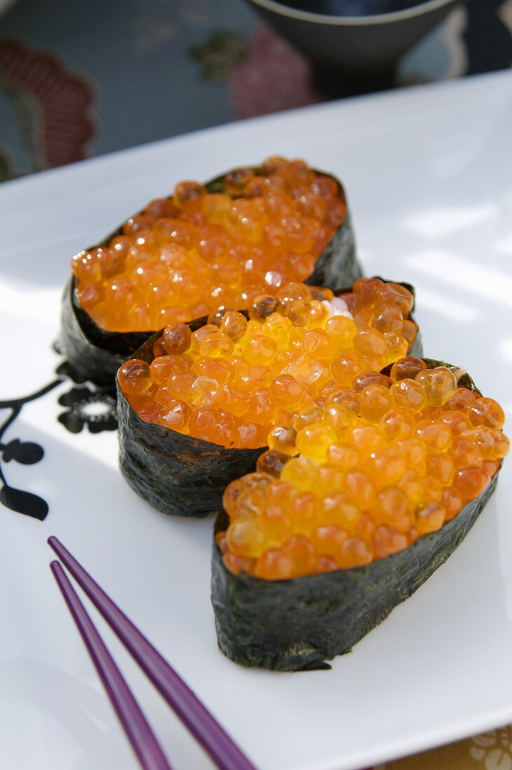 Three maki sushi with salmon caviar