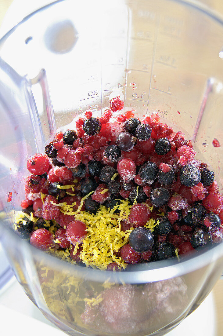 Mixed, frozen berries in liquidizer for berry drink