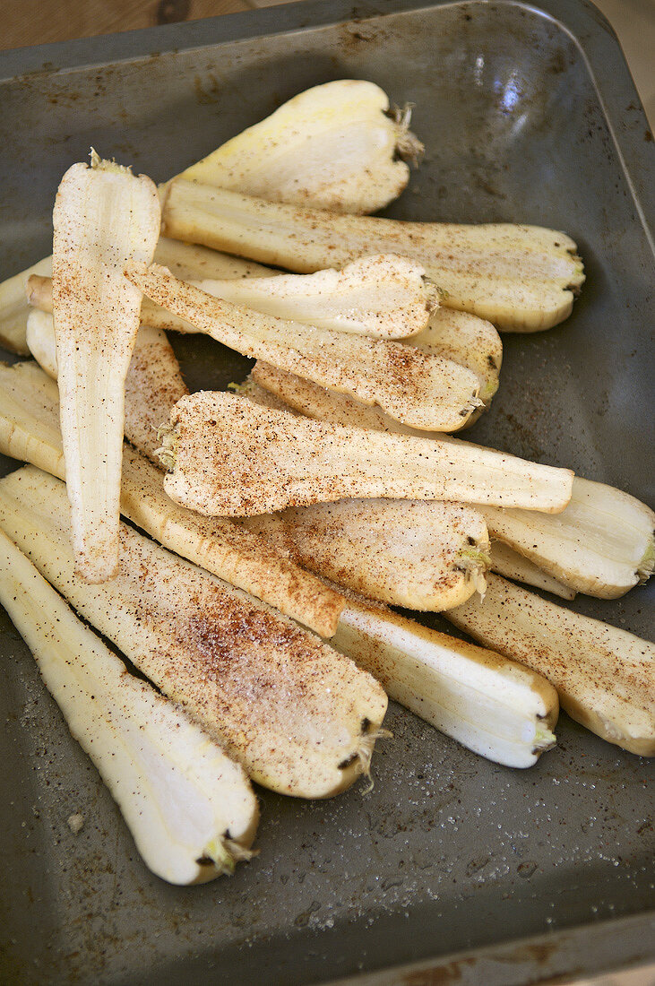 Halved parsnips on a baking tray