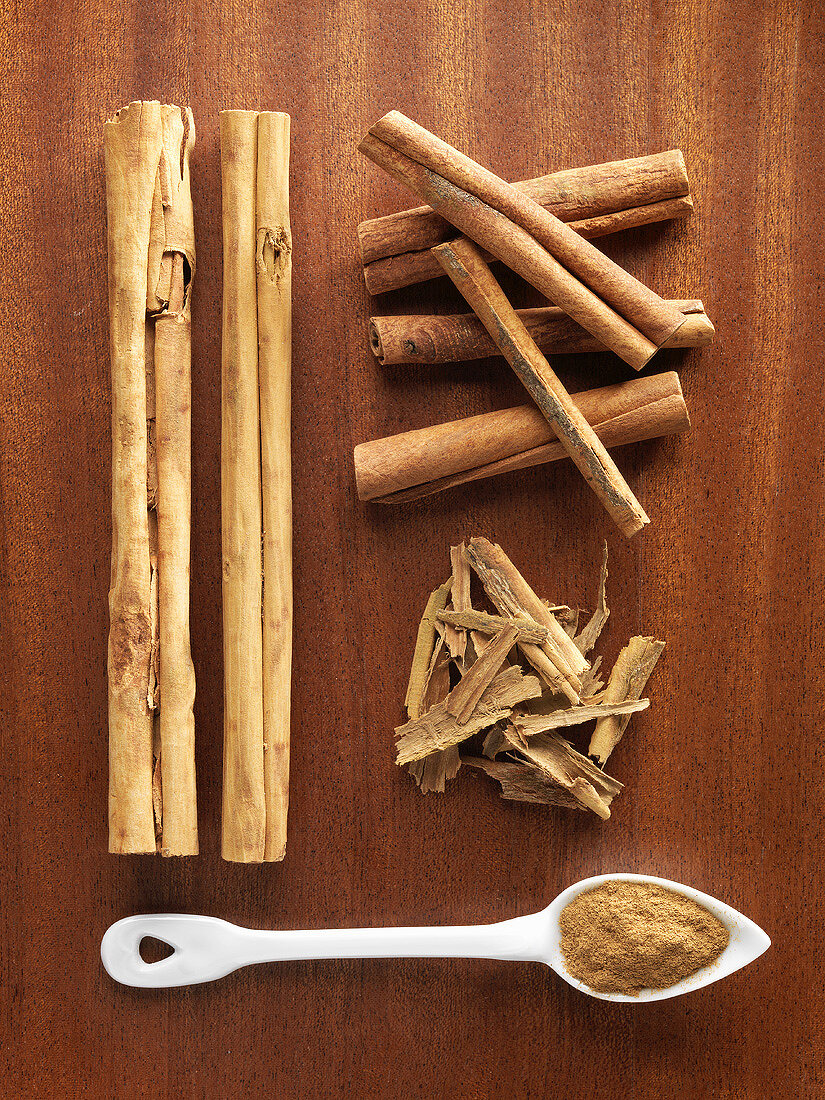 Cinnamon bark & sticks & ground cinnamon on wooden background