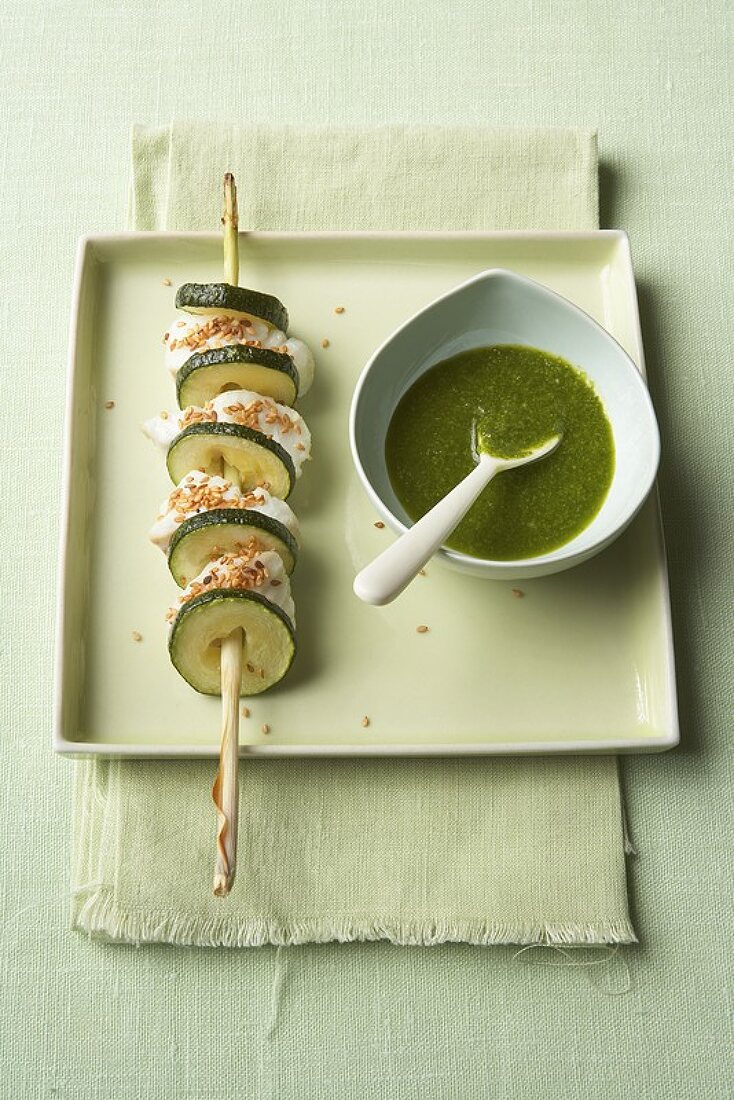 Sesame-coated cod & courgette slices on skewer with pesto