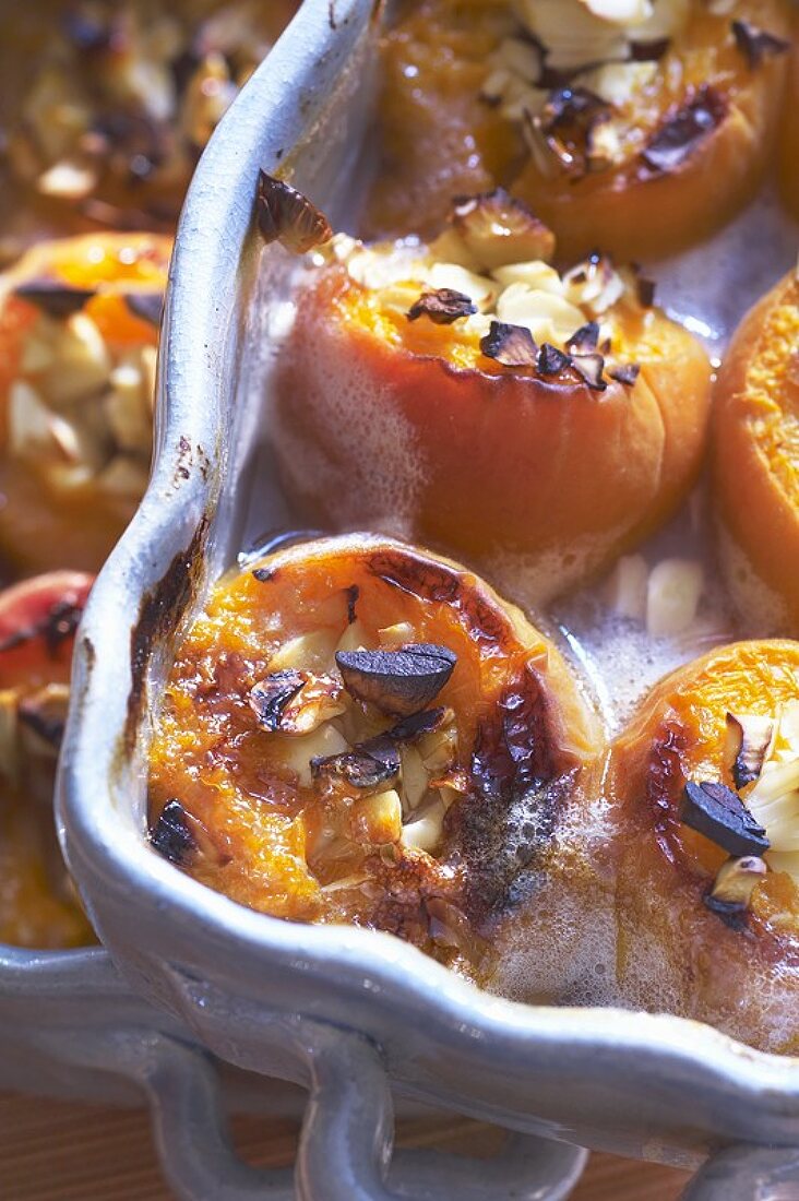 Baked, stuffed apricots in baking dishes