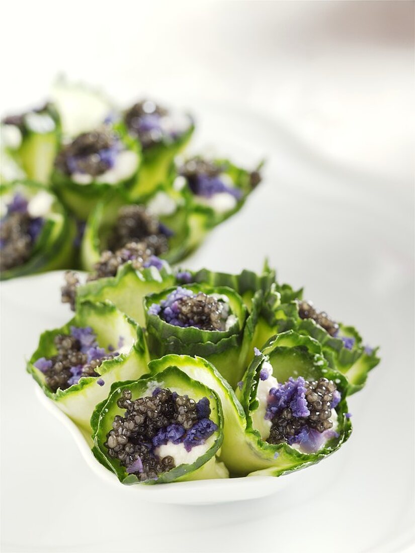 Cucumber rolls filled with sour cream and caviar