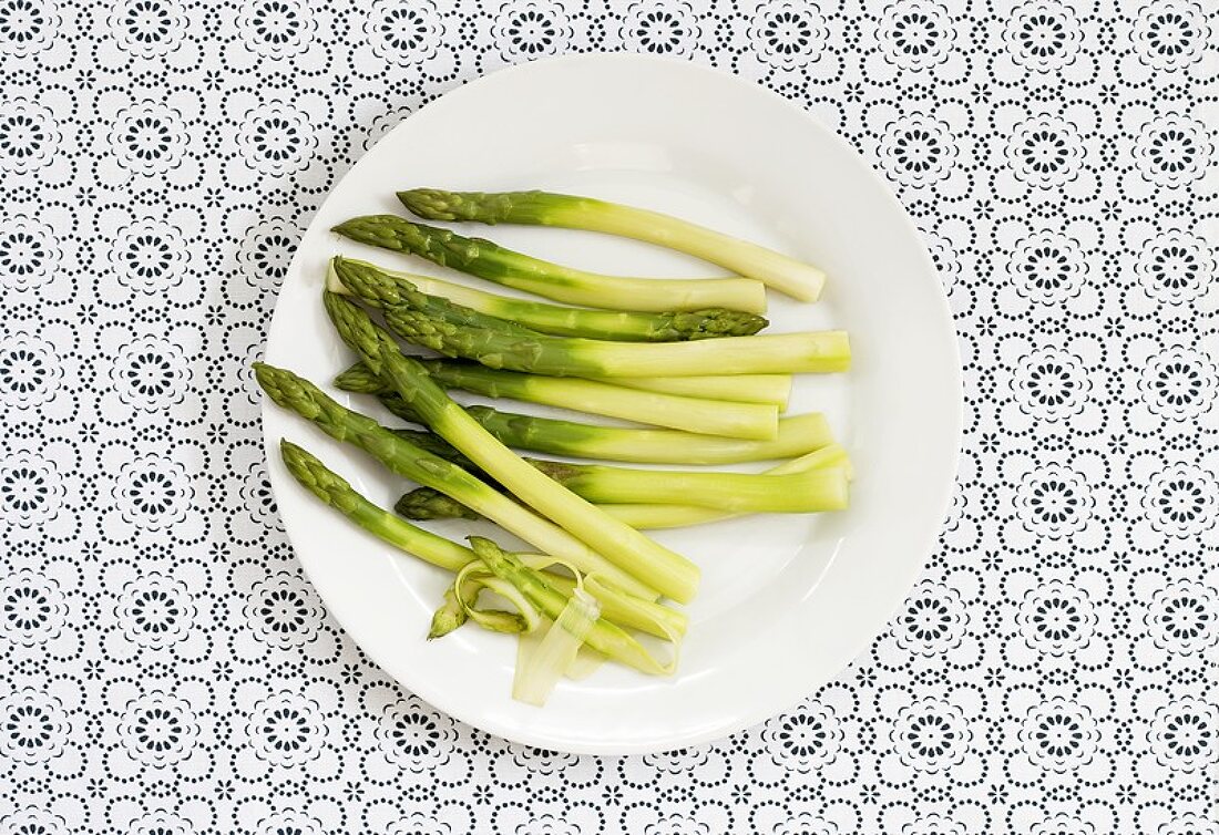 Peeled green asparagus on a plate