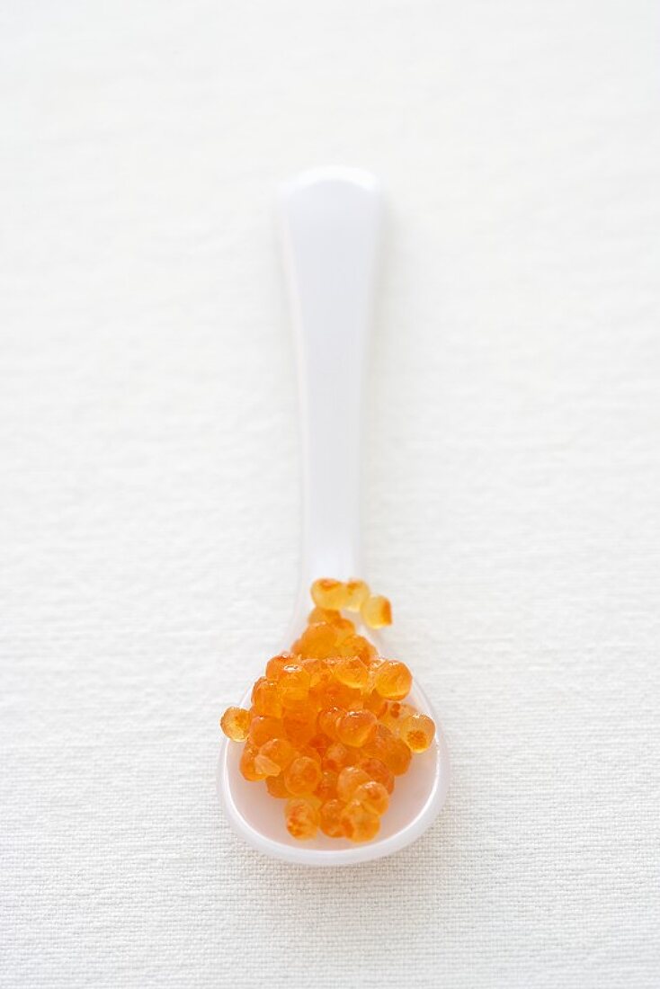 Trout caviar on a plastic spoon