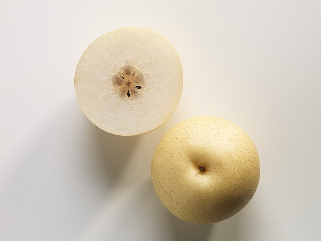 Whole Nashi pear and half a Nashi pear