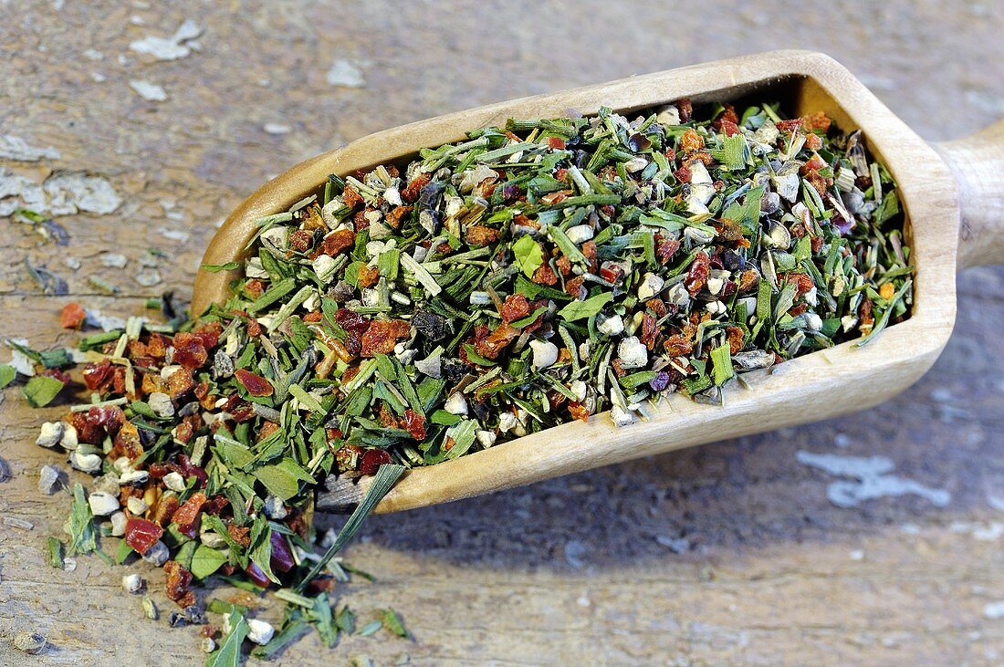 Herb and pepper mixture in a wooden scoop